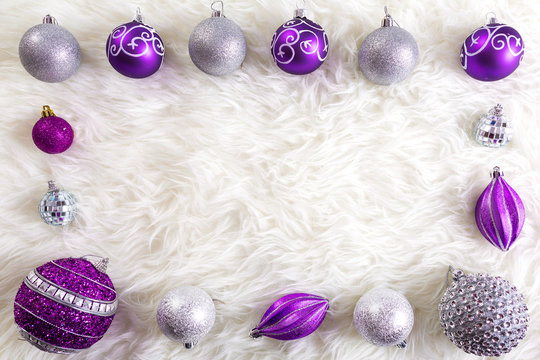 Frame Made By Purple And Silver Christmas Baubles On Fluffy Carpet