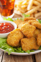 fast food chicken nuggets with ketchup french fries cola