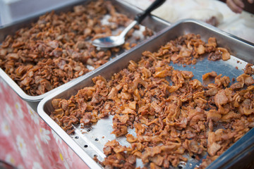 Pork fried in tray for sale in the market