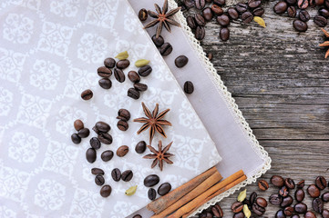 Close-up of cinnamon, anise and coffee beans on a rustic wooden