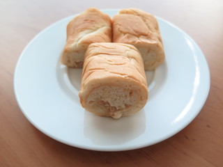 Slices of bread tuna in white Ceramic on background