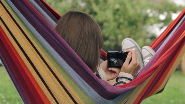 Girl in hammock taking photos