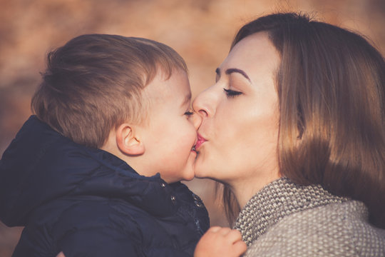 son and mom kissing