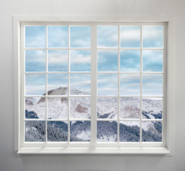 Modern residential window with snowy mountain and clouds