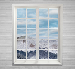 Modern residential window with snowy mountain and clouds