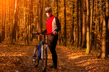 Man with bicycle riding country road