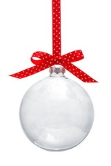 Transparent Christmas ball hanging on red ribbon against white background