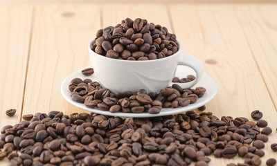 Cup of coffee full of coffee beans