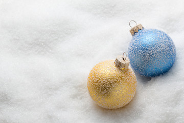 Blue and golden christmas balls on snow 