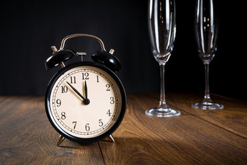 Alarm clock showing almost midnight. New year symbol.