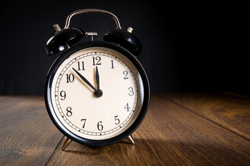 Alarm clock showing almost midnight. New year symbol.