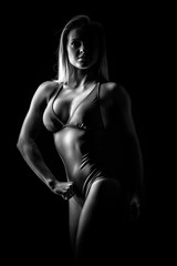 Sexy athletic woman isolated on black