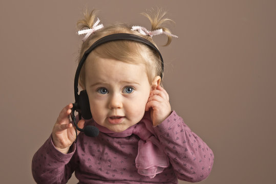 Bbaby girl  listening on a headphones