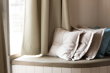 Pillows On Build-In Sofa In The Living Room With Sunlight From T
