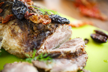Meat baked with prunes and tomatoes