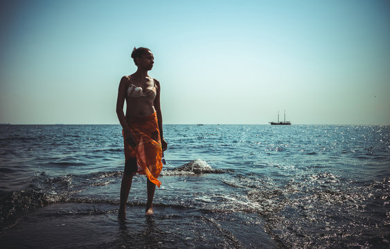 african black woman on a natural coastal rock
