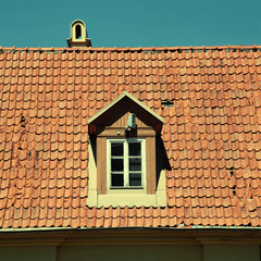 Retro red tile roof of old house