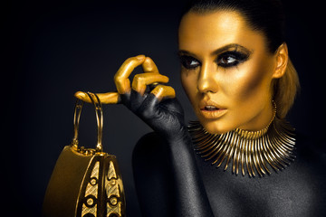 Beautiful woman portrait in gold and black colors - 96676504