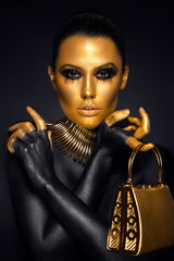 Beautiful woman portrait in gold and black colors - 96676518