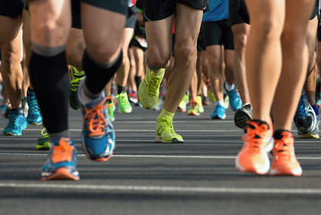 Marathon running race, runners feet on road