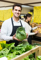 shop people standing near cabbage in grocery