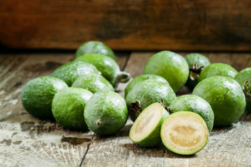 Slices of fresh pineapple guava at the old wooden table, selecti