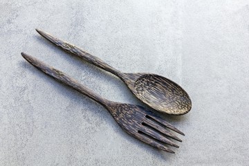 Wooden spoon and fork on tile texture 
