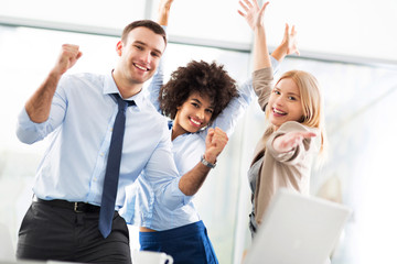 Business people cheering with arms raised