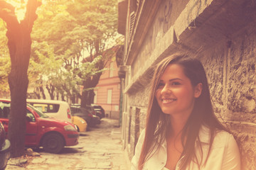 Portrait of young and beautiful brunette on the street.