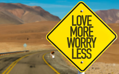 Love More Worry Less sign on desert road