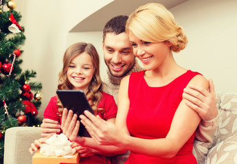 smiling family with tablet pc