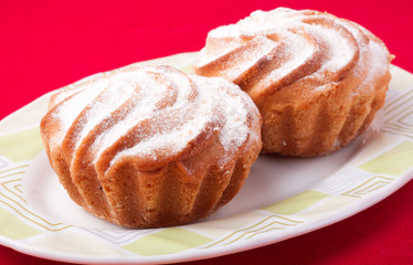Two Delicious Homemade Muffins with Raisins and Sugar Powder