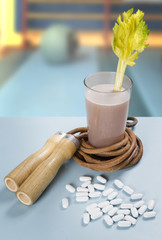 table with rope daltare protein shake and celery, amino acids and vitamins
