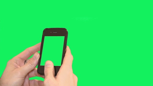 Hands on smart phone over blank green screen - 1080p. Close shot of hands using a smartphone over a green screen background.