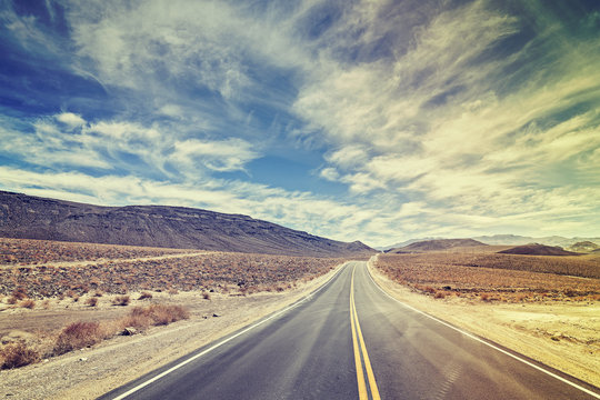 Vintage stylized endless country highway in Death Valley, USA.