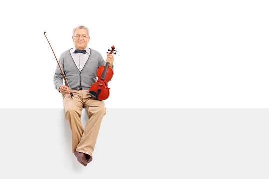 Mature violinist sitting on a panel