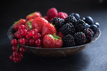 Fresh berries in bowl, antioxidant concept