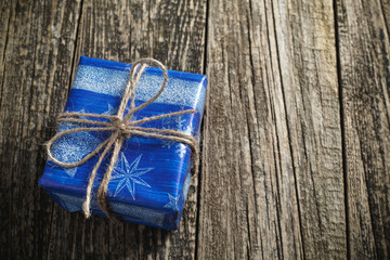 One  blue Christmas present on wooden table.
