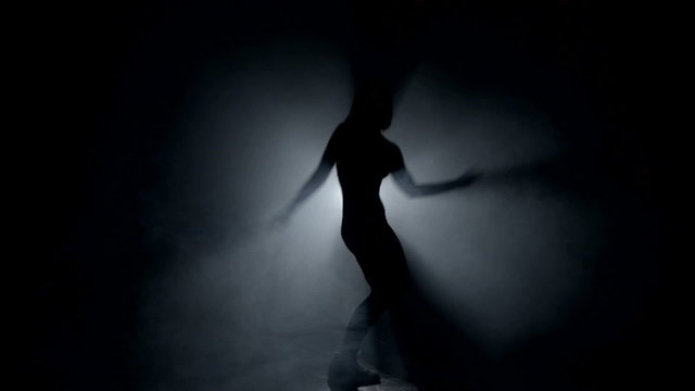 Amazing dance against the light in the dark