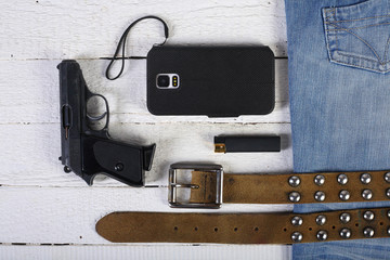 Planks, phone, gun, blue jeans and belt