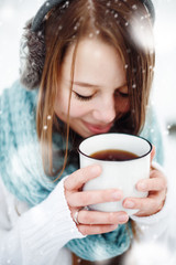 Female Drinking Hot Drink Outdoors in Winter