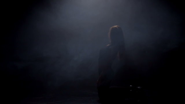 Beautiful woman dancing in the dark