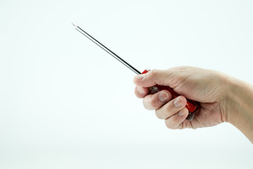 A hand holding red screwdriver
