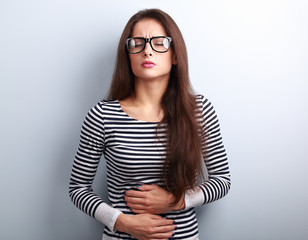 Beautiful stressed business woman in eyeglasses suffering from p
