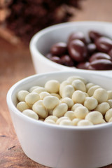 Chocolate dragee in porcelain bowl