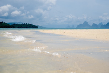 The quiet waves go in coral sands beach at Phang Nga Bay near Krabi and Phuket