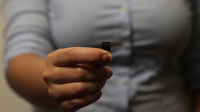 Woman holds SD card
