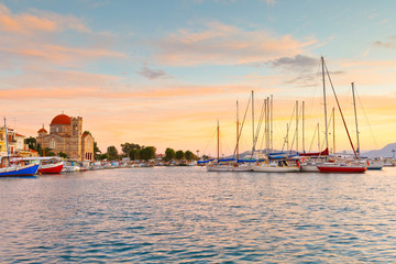 View of Ekklisia Isodia Theotokou church and sail boats  in the harbour of Aegina island, Greece