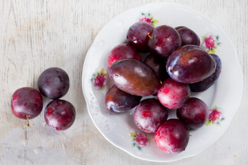Ripe plums and cherry-plum on a table