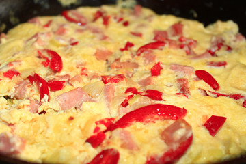 cooking of omelet with red paprika